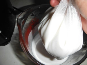 Squeeze the nut milk out of the bag